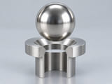 Conceptual CGI: Complete AISI 302, 304 or low-carbon 304L austenitic stainless steel sphere above a conical annular seat and an aligned open vertical bore; axial component contact concept
