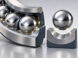 Conceptual CGI: a polished steel sphere on a curved raceway with restrained lubricant meniscus, separate sphere and raceway showing point-contact geometry