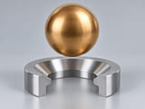 Conceptual CGI: Complete bronze sphere, separate annular seat and flat metallic coupon; material and contact comparison