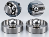 Conceptual CGI: two identical silver spheres in separated circular polished steel trays illustrating two distinct steel-grade options; no visible difference claimed, no text