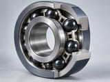 Conceptual CGI: Hybrid bearing engineering cutaway with dark ceramic balls in silver steel inner and outer raceways and a simple cage; all balls spaced realistically and contact aligned