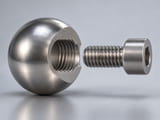 Conceptual CGI: Exploded view of a single stainless sphere with a circular blind threaded bore, a short matching screw aligned coaxially but separated, visible thread profile and substantial remaining wall, no measuring values