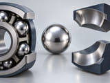 Conceptual CGI: one polished silver sphere with enlarged curved contact surfaces separated around it showing ball-raceway fit; no stress field or measurements