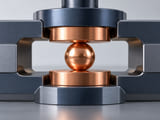 Conceptual CGI: electrical test contact assembly with one copper sphere gently held between two flat copper contacts, no sparks or powered circuitry